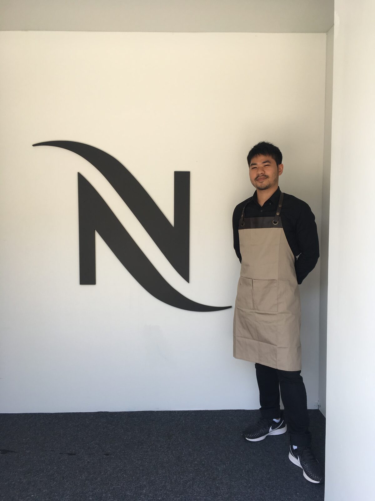 Manachai in a Nespresso boutique apron